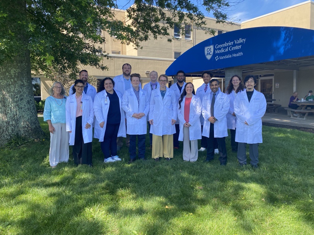 Group photo of GVMC Family Medicine residents and program leaders standing outside building.