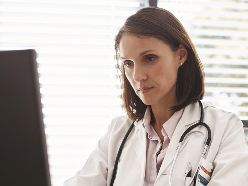 Physician working on computer.