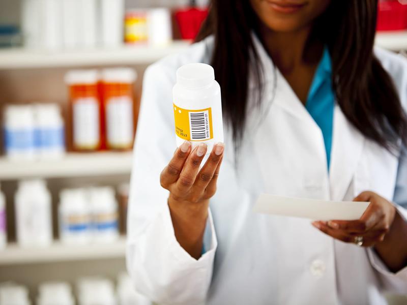 Picture of pharmacist with prescription bottle