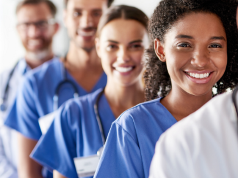 Physicians standing in line, smiling
