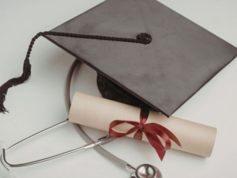 Graduate cap, diploma and stethoscope