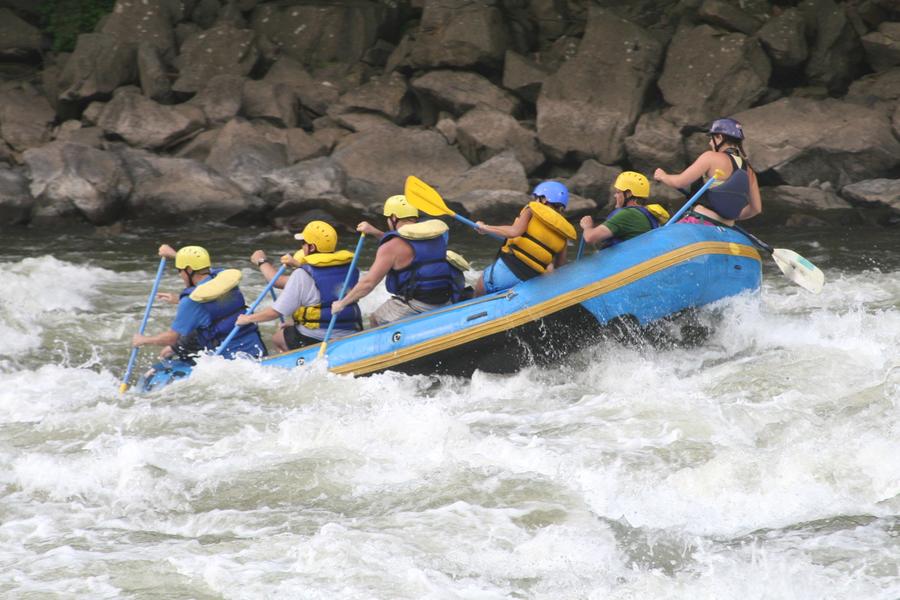 a group of people white water rafting down a river