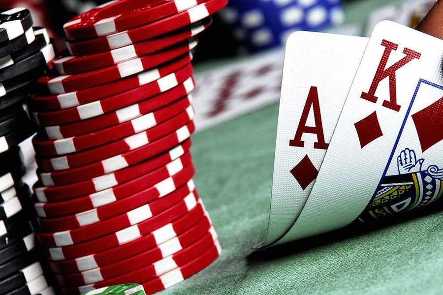 close up of cards and a stack of poker chips