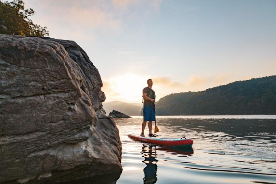 man paddle boarding on Summersville Lake