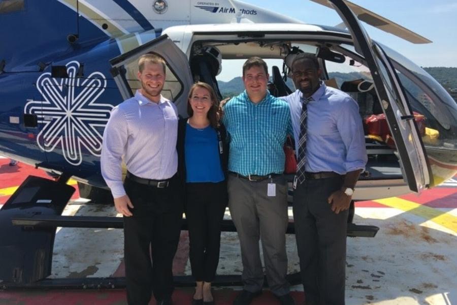 EM residents in front of HealthNet helicopter