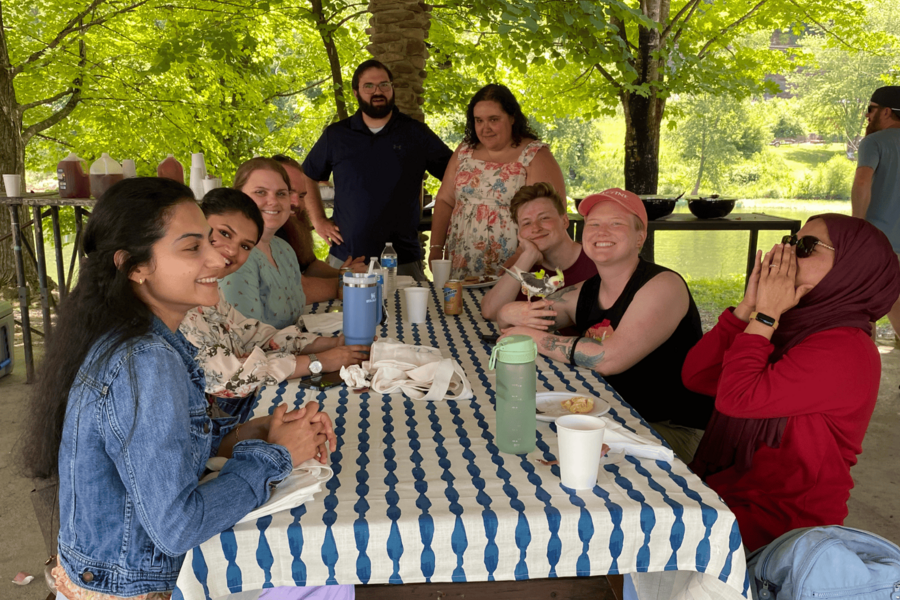 Group photo at table during orientation picnic