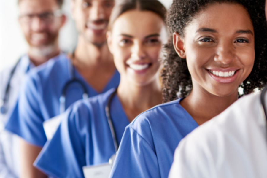 Physicians standing in line, smiling
