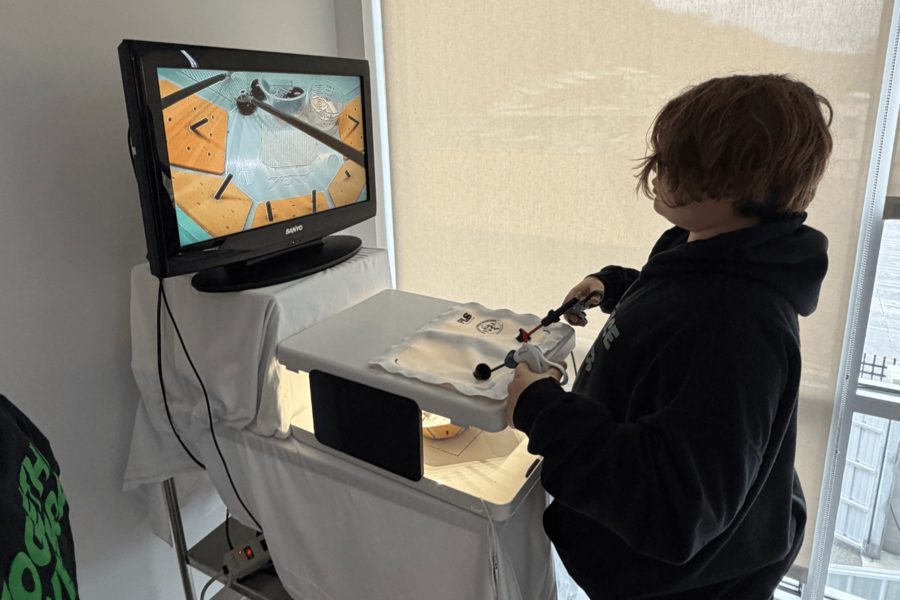 Student using surgical simulation technology