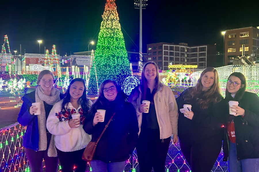 CAMC Psychology interns pose with hot chocolate for group photo at Light the Night holiday event