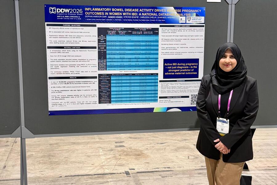 Dr. Hamid presenting research poster at conference.