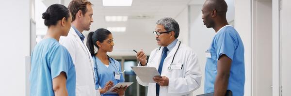 Physician and residents talking in group