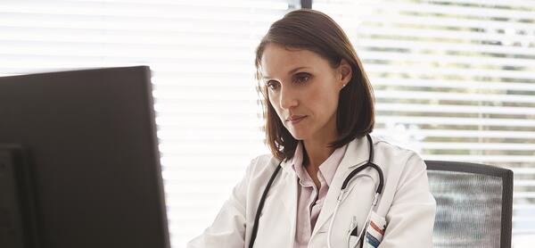 Physician working on computer.