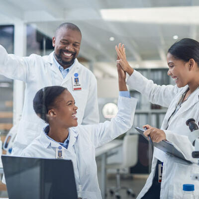 Three students interacting in a clinical health setting