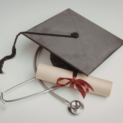 Graduate cap, diploma and stethoscope